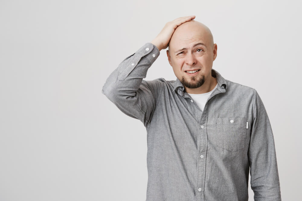 confused looking bald man